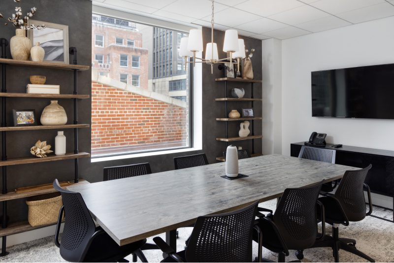 new york office interior meeting space with table and mounted monitor
