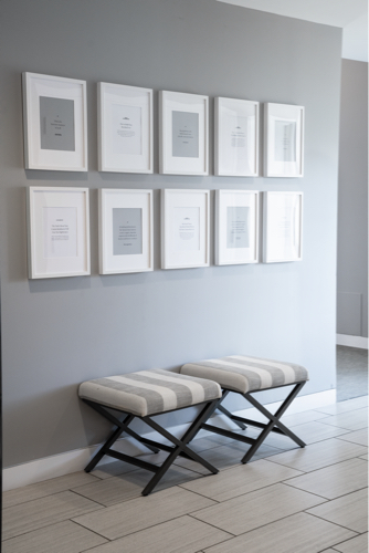 bench in hallway with pictures on wall